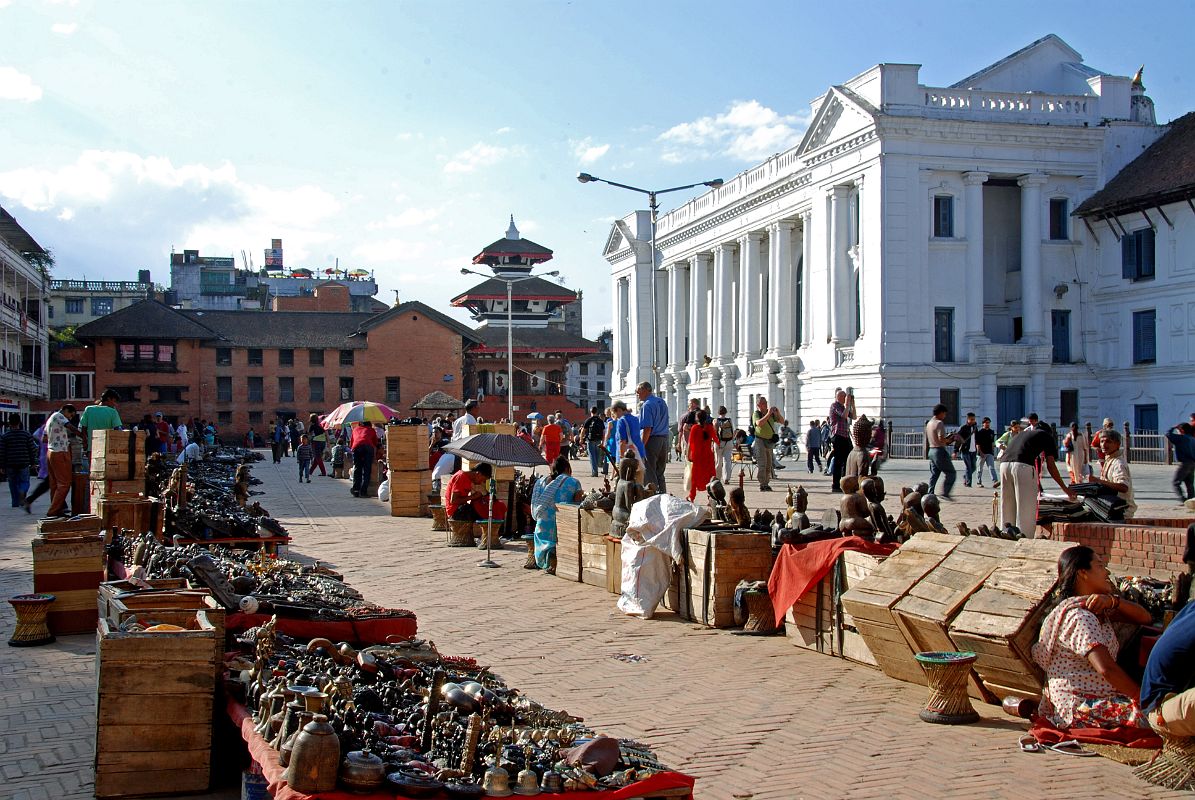 Kathmandu Durbar Square 01 01 Basantpur Square Market Just Outside Durbar Square Basantapur Square is a large open plaza at the south-eastern entrance to Kathmandu Durbar Square, where souvenir sellers set up their stalls in long lines to await the tourists. The white columned building on the right is the Gaddi Baithak, part of the Royal Palace complex built in the 1908 after King Jung Bahadur Rana returned from a trip to England, where he developed a taste for western neo-classical architecture. The main part of Durbar Square is straight ahead.
